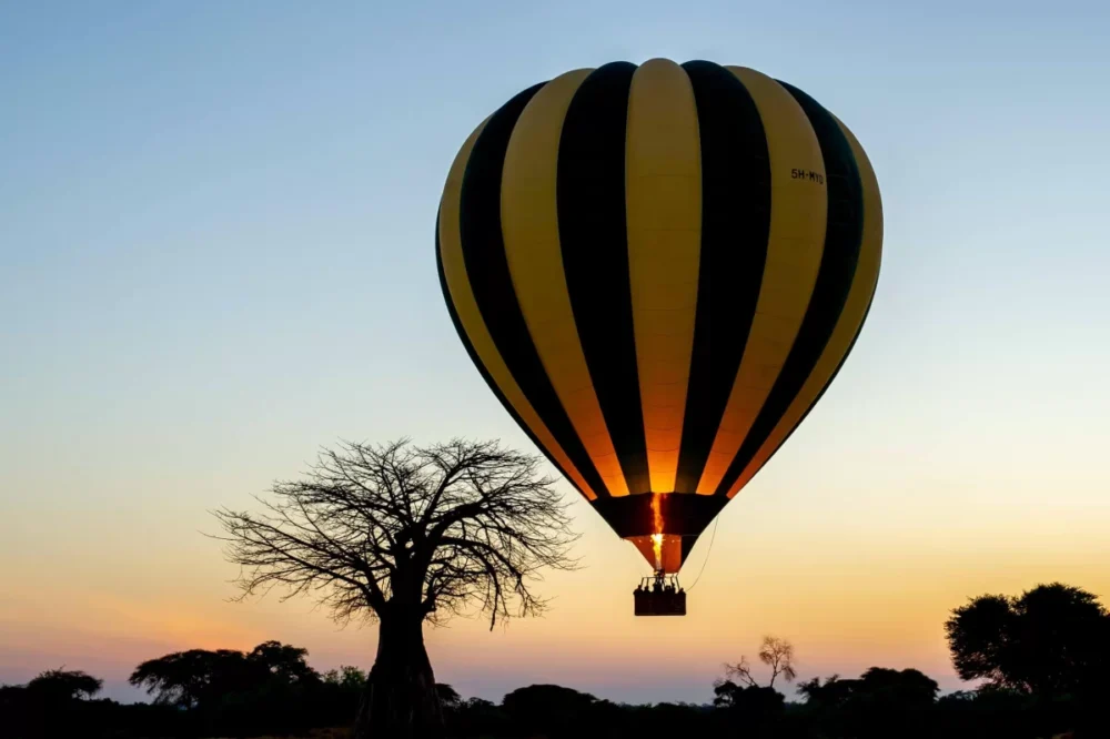 Hot air balloon safari floating over Ruaha National Park river valley, Tanzania