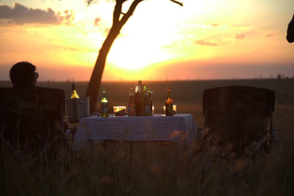 12-Day Ultimate Tanzania Safari & Zanzibar Beach Holiday 21 Luxury Tanzania safari honeymoon couple enjoying private bush dinner in Serengeti National Park