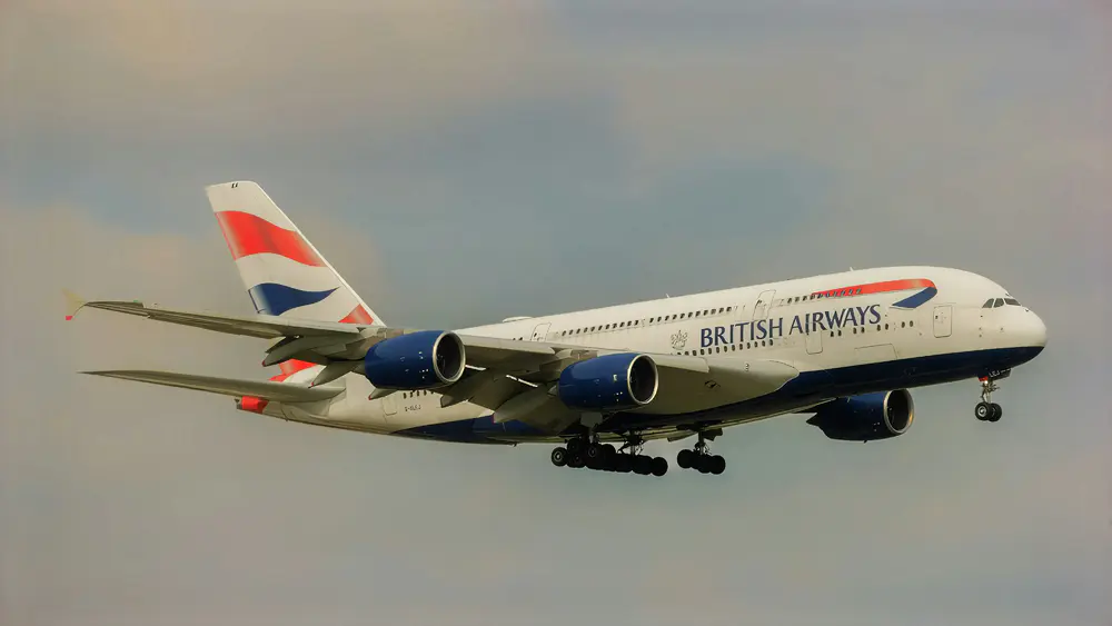 A British Airways Airbus A380 makes its final approach under clear skies.
