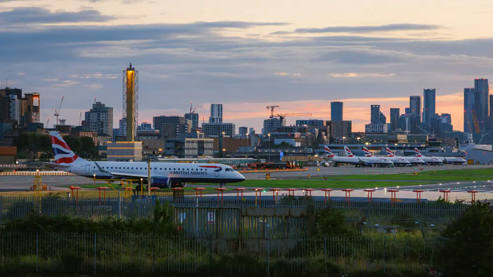 A British Airways aircraft lining up to runway at London City Airport for departure.