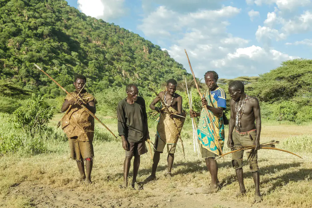 Hadzabe tribe hunter during a traditional hunting experience near Lake Eyasi, Tanzania, showcasing the ancient skills and unique lifestyle of one of Tanzania’s indigenous communities.